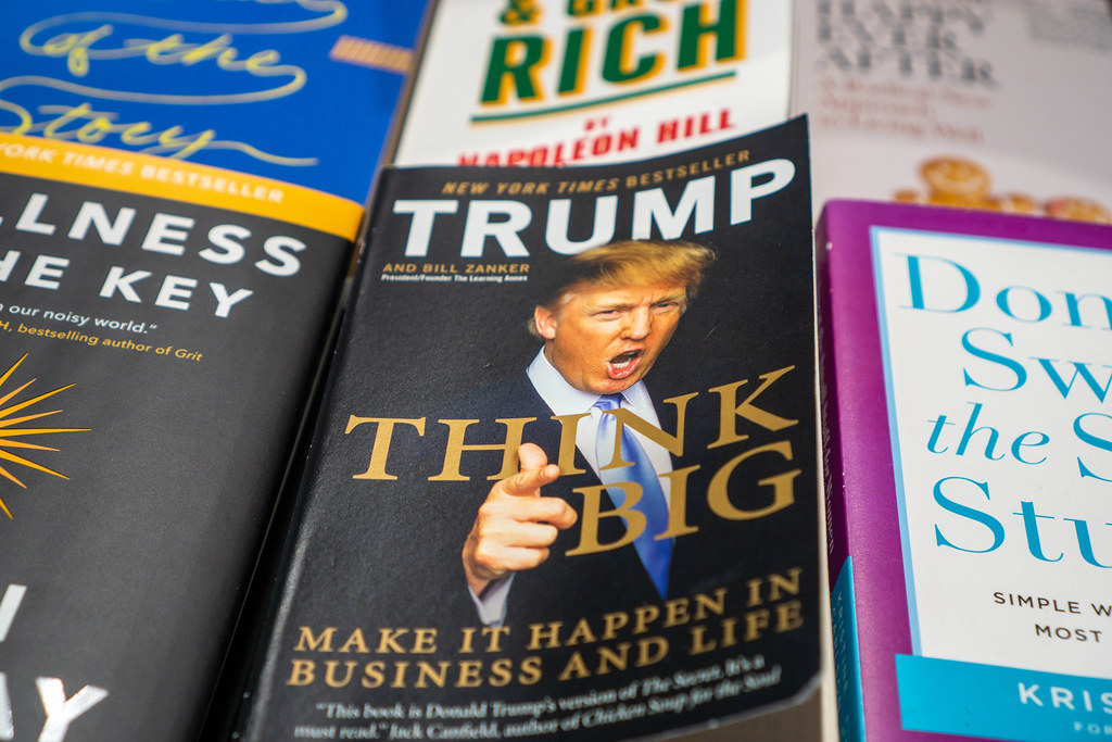 Close Up Photo of Trump's Paperback Book Think Big among other Business Books on a Table in a Bookstore