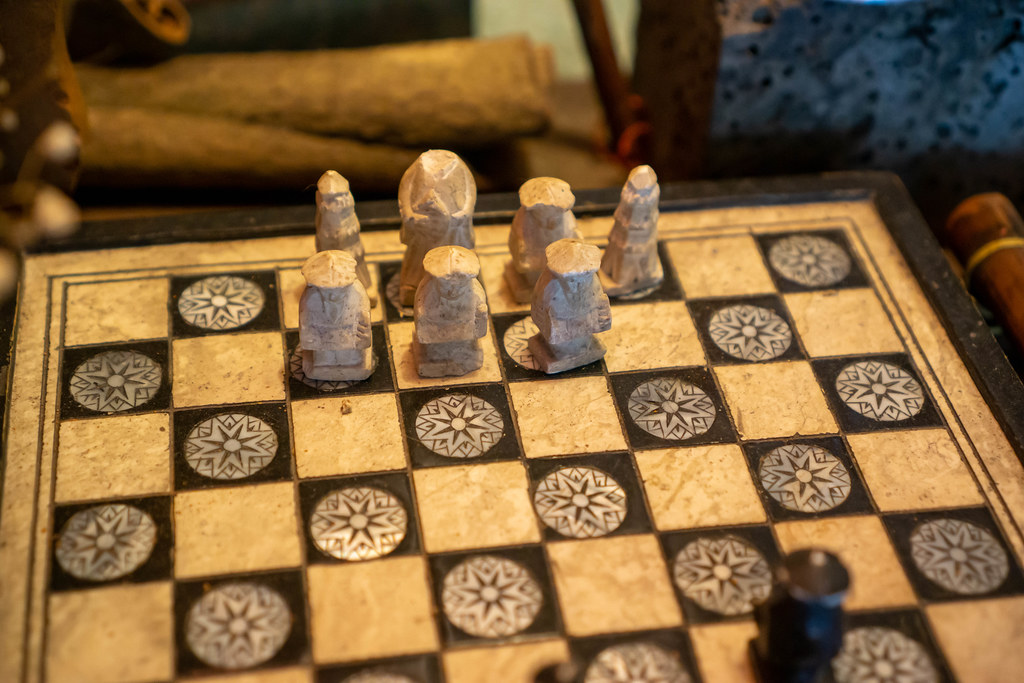 Close Up Photo of Vintage Chess Set with Hand Carved Stone Figures and Solid Wooden Chess Board