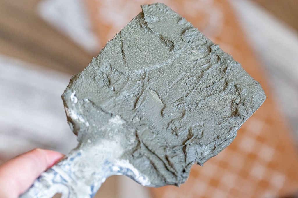 Close up, spatula with plaster or cement glue