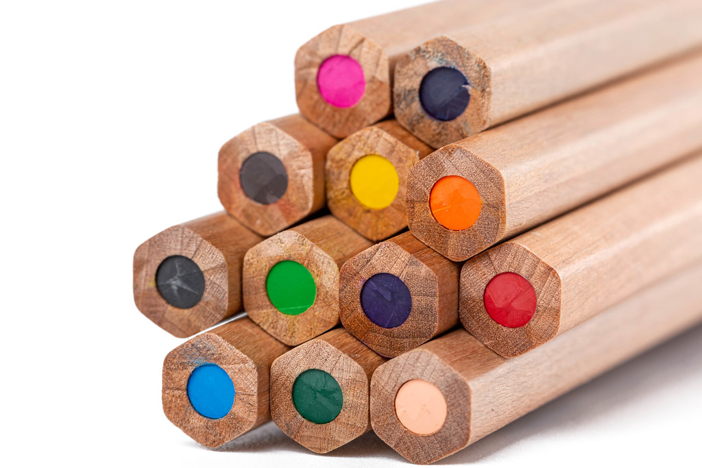 Close-up, unsharpened wooden crayons on white