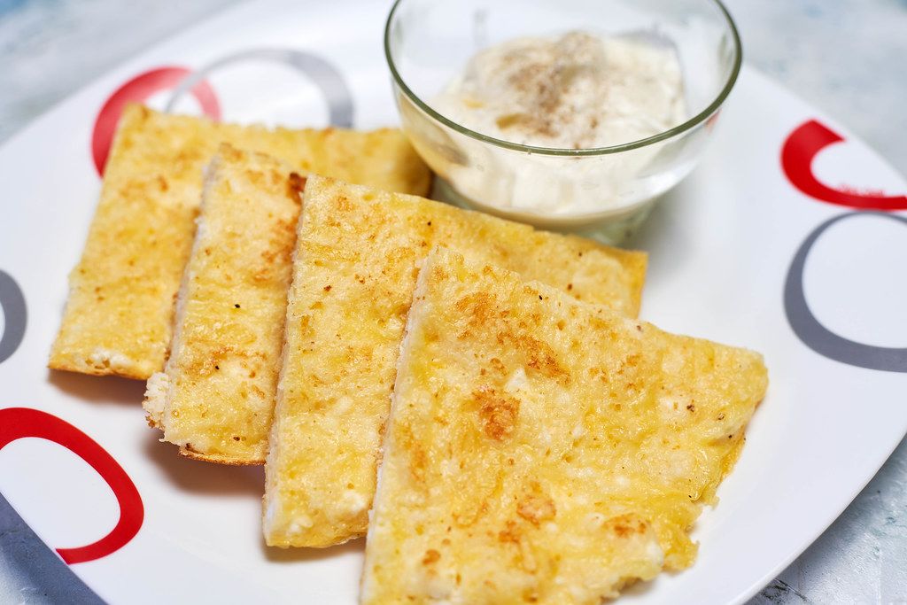 Close-up view of healthy breakfast set - Gluten-free khachapuri with sour cream