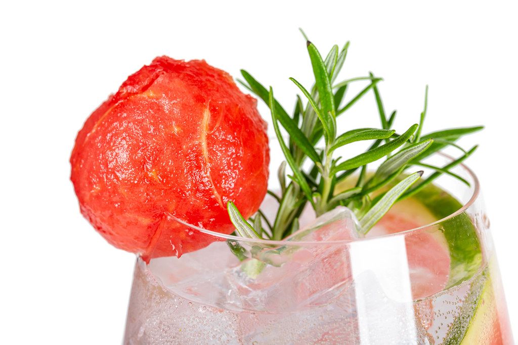 Close-up, watermelon cocktail with ice cubes and rosemary branches