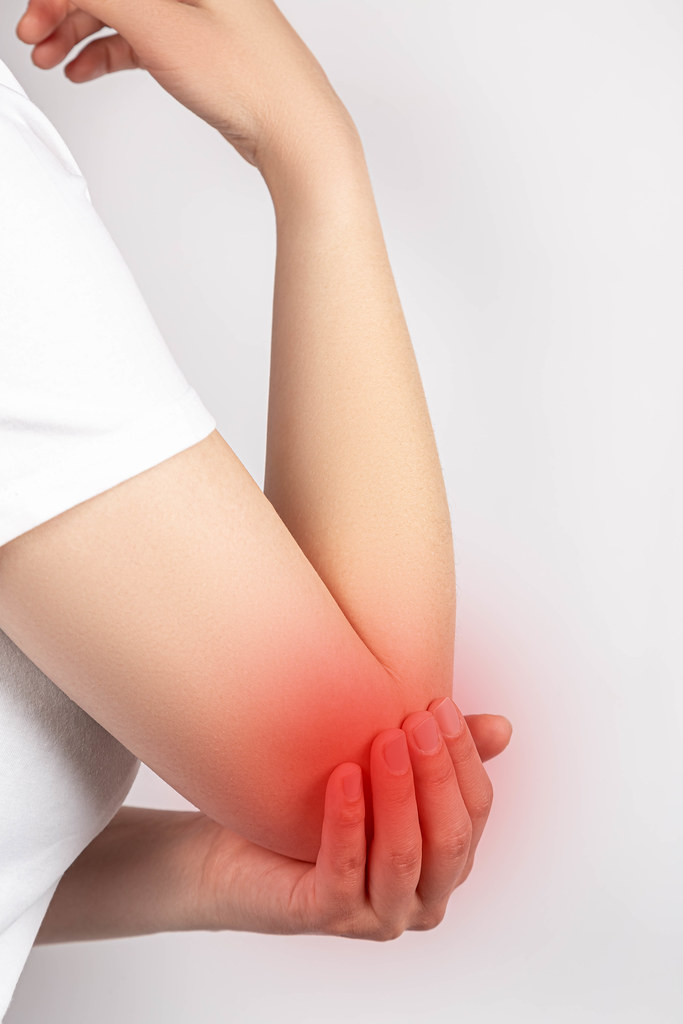 Close-up, woman experiencing elbow pain