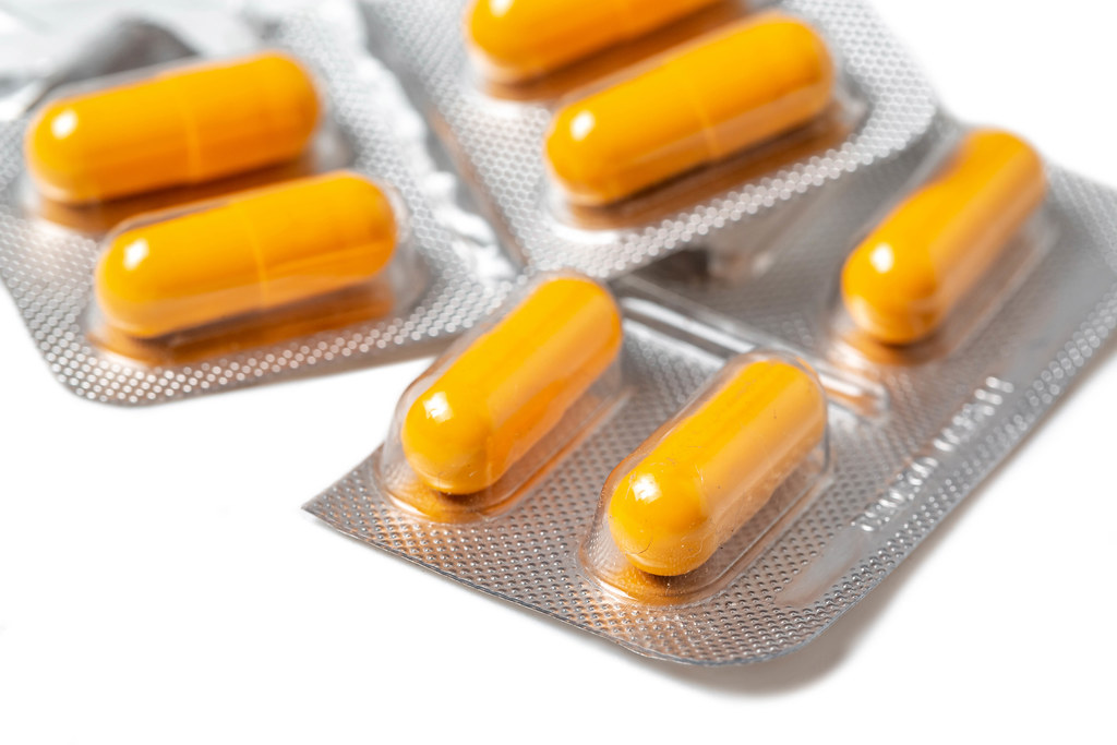 Close-up, yellow medical capsules in a package
