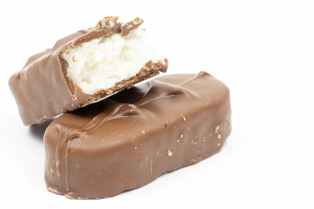 Coconut chocolate bar above white background with copy space