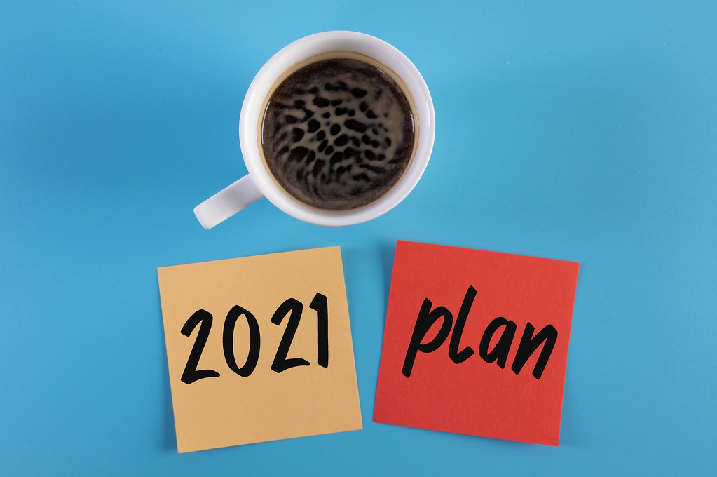 Coffee and sticky notes with 2021 Plan text on blue background