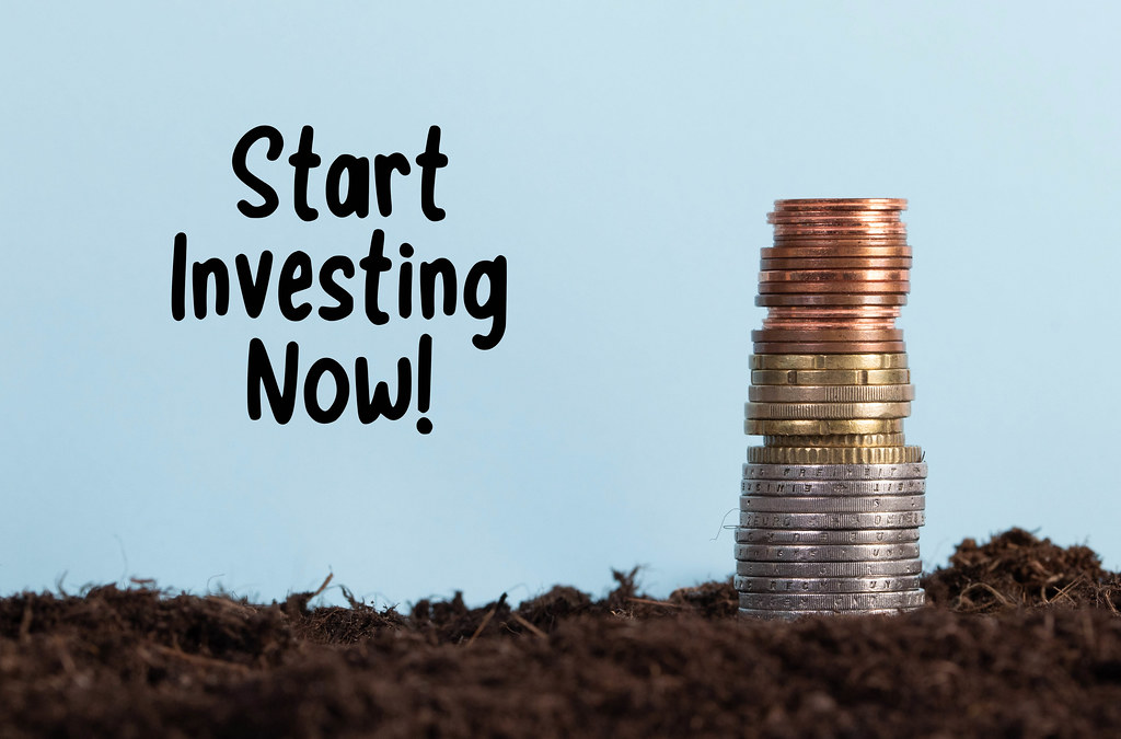 Coin stack on a dirt and Start Investing Now text