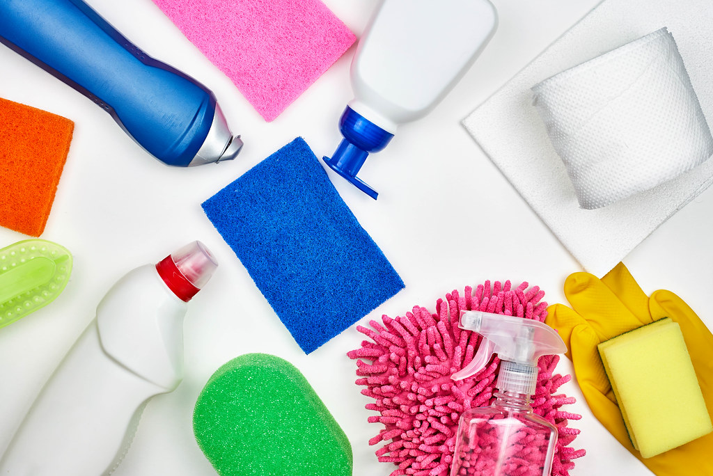 Collection of cleaning supplies on white