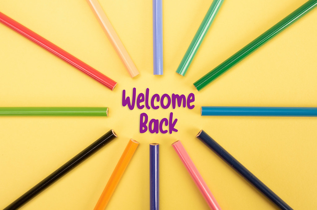 Colored pencils with Welcome Back text on yellow backgorund