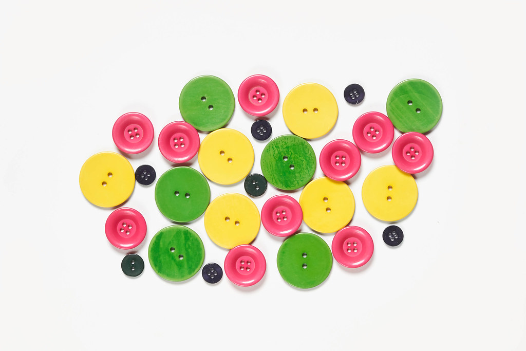 Colorful sewing buttons on white
