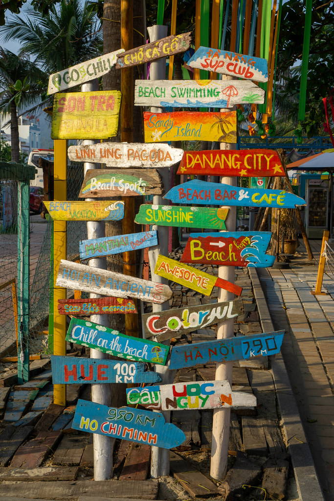 Colorful Wooden Signboards with City Names, Sights and Holiday related Words at the Entrance of a Beach Bar in Da Nang, Vietnam
