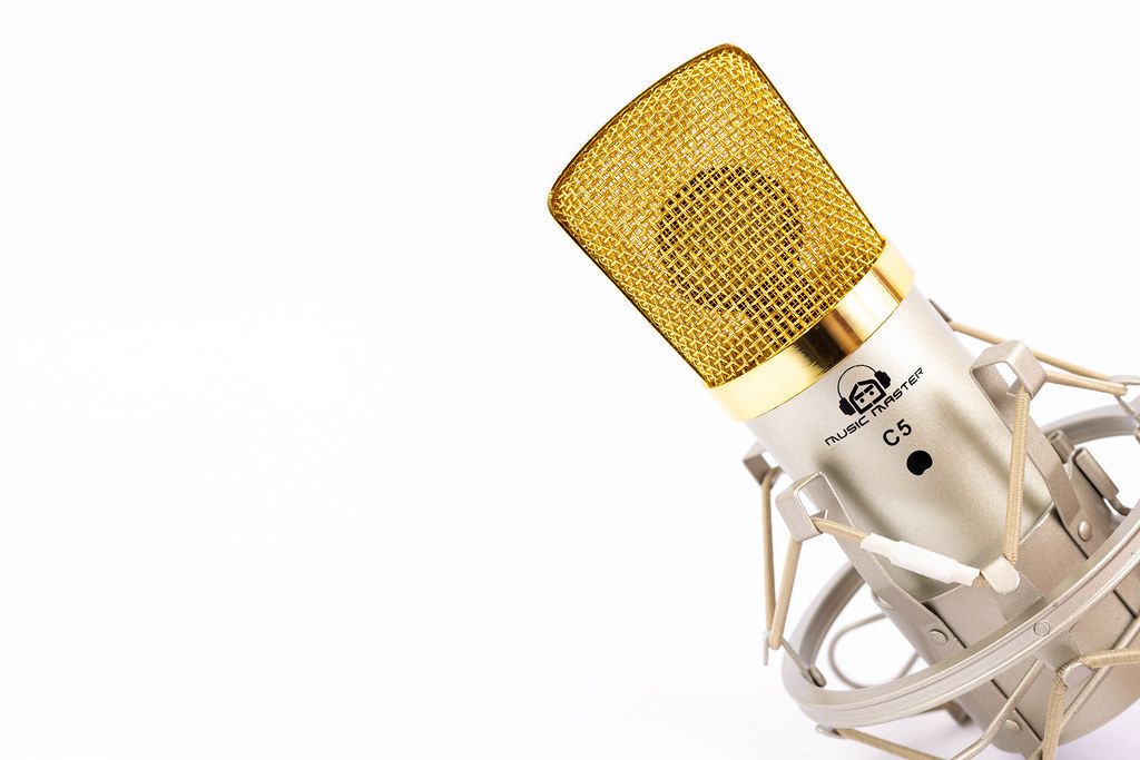 Condenser Studio Microphone with golden cap and copy space