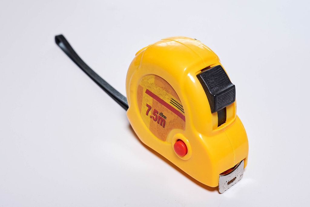 Construction tape measure on white background
