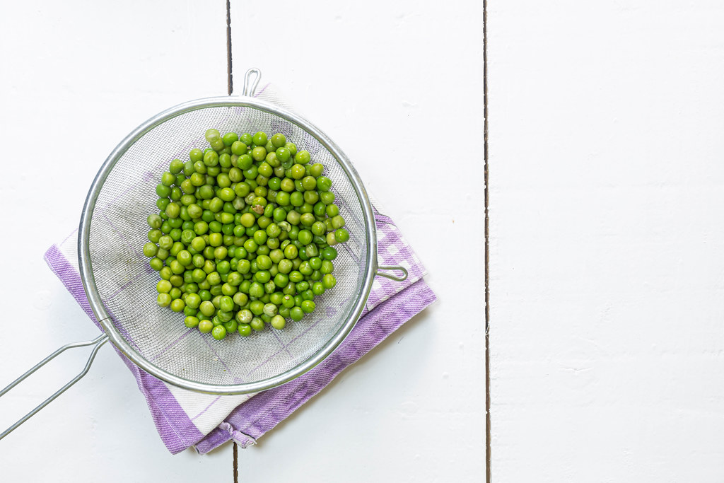 Cooked Green Peas in the bowl with copy space