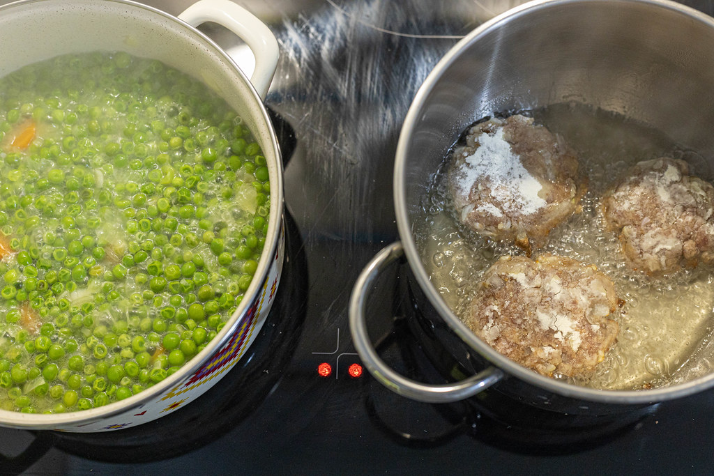 Cooking Green Peas and frying Meatballs on the stoove