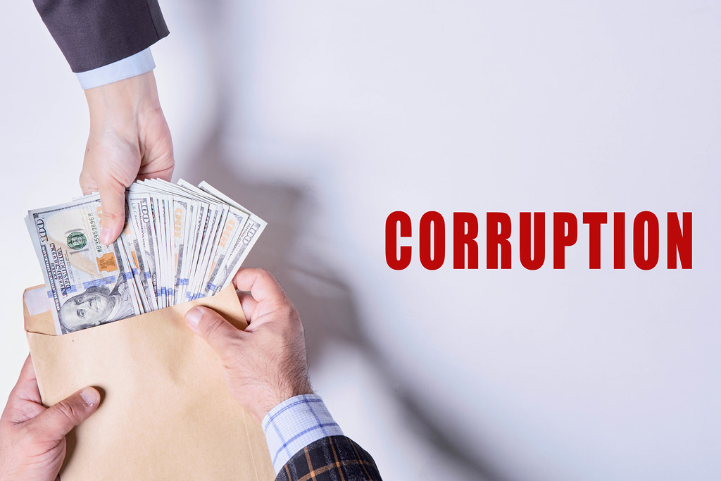 Corruption - giving a bribe in envelope