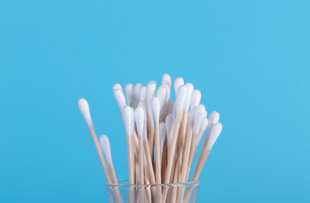 Cotton ear buds isolated on blue background