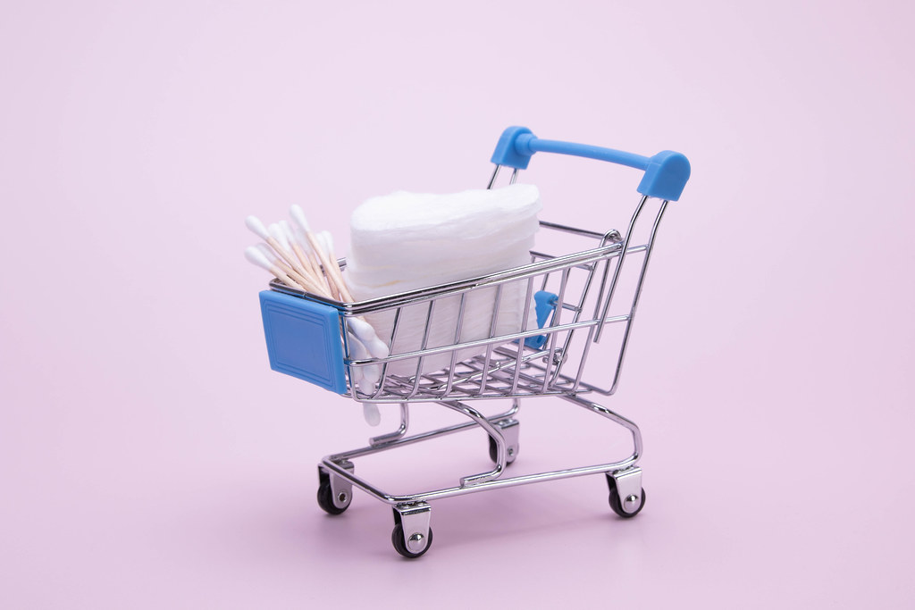 Cotton swabs and cosmetic cotton pads in a shopping cart