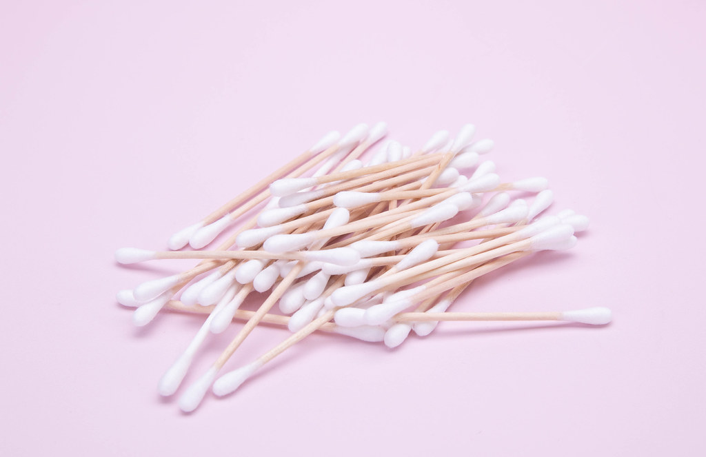 Cotton swabs on a pink background