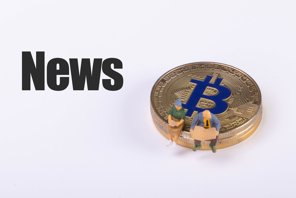 Couple sitting on a Bitcoin coin and News text on white background