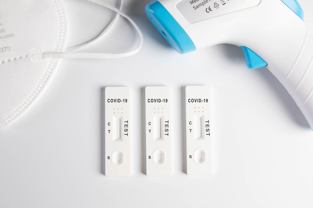 Covid 19 Antigen tests with digital thermometer and face mask