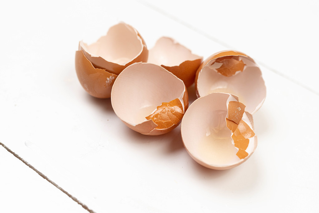 Cracked Egg Shells on the white wooden table