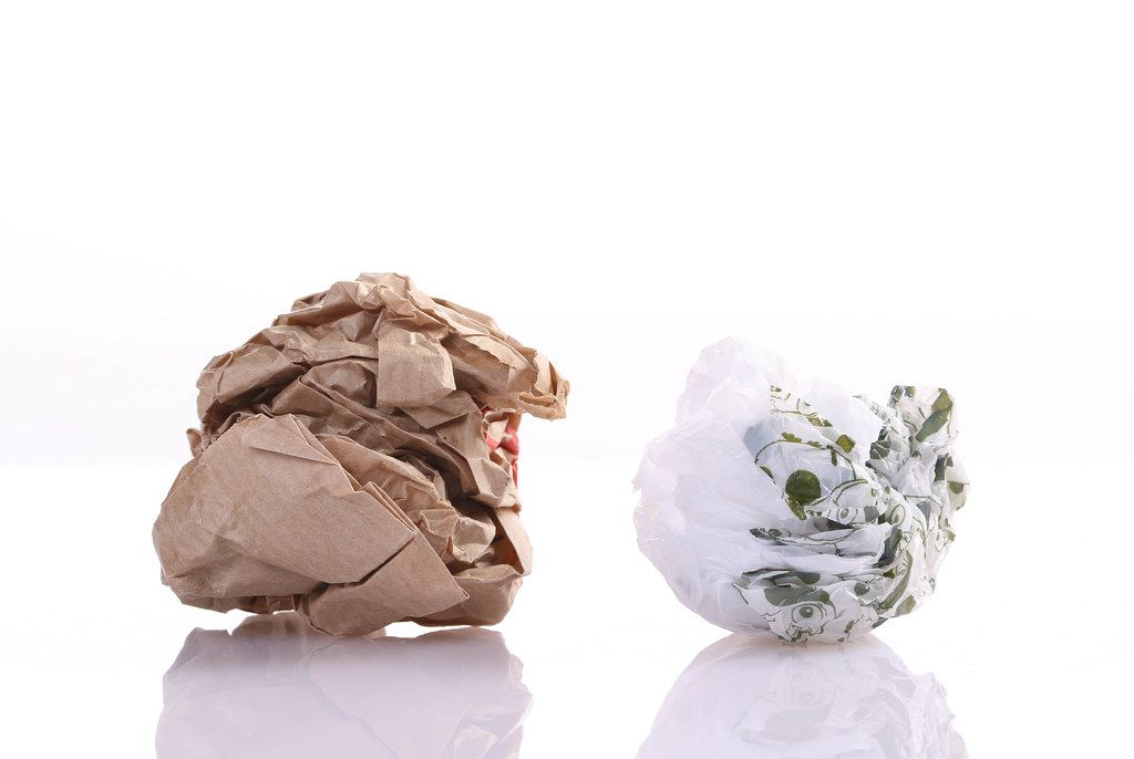 Crumpled paper and plastic bag on white background