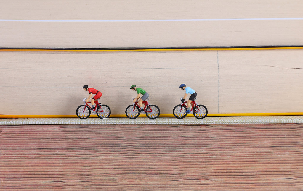 Cyclists riding on books