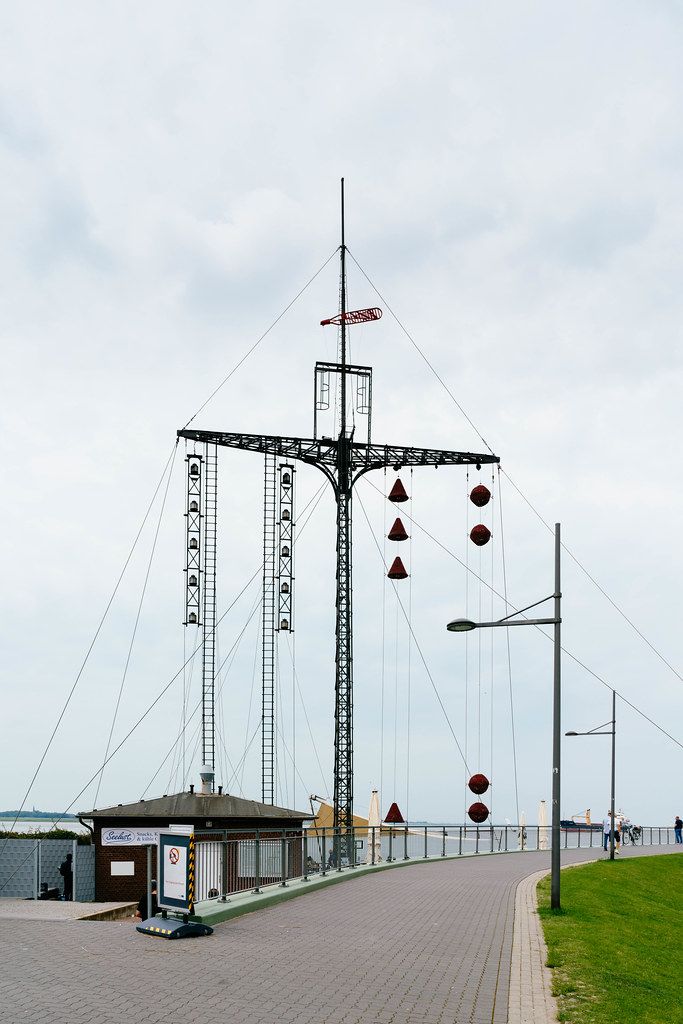 Decorative mast with bells next to the beach and Maritime Museum
