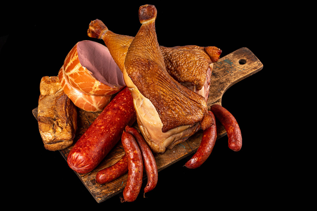 Delicious background with different sausages and smoked meat