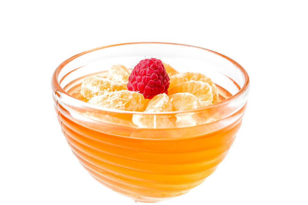 Delicious orange fruit jelly on white with tangerine