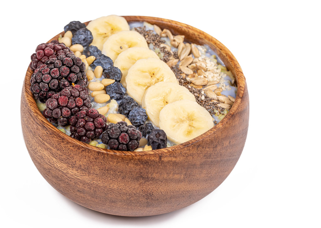 Diet and healthy food, cereal with seeds, pine nuts, blackberries, banana and blackthorn