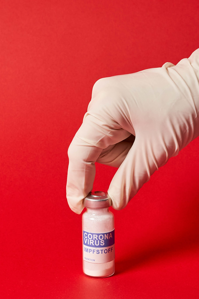 Doctor hand in protective medical gloves takes a covid-19 vaccine dose