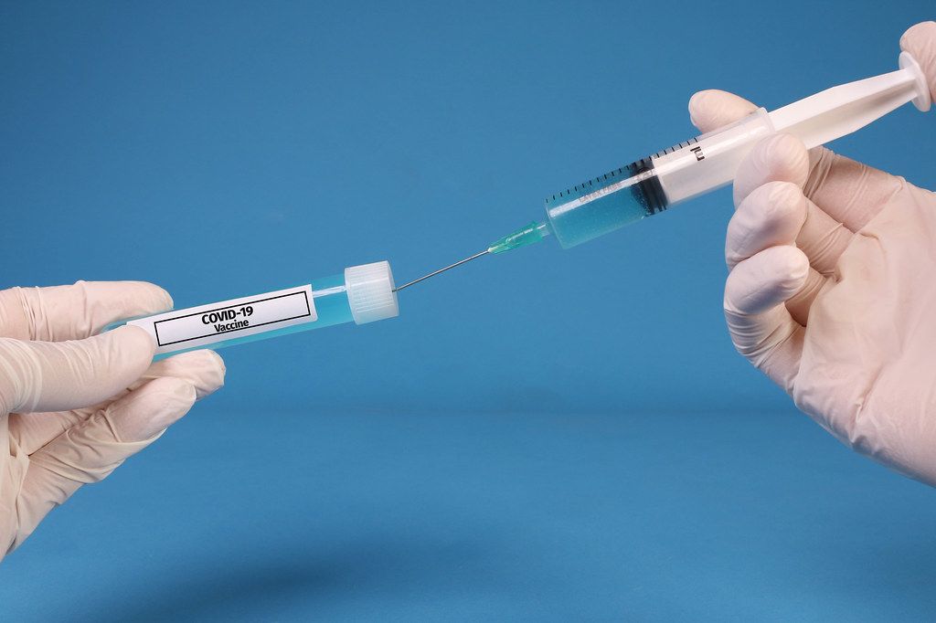 Doctor or nurse filling a syringe with Covid-19 Vaccine