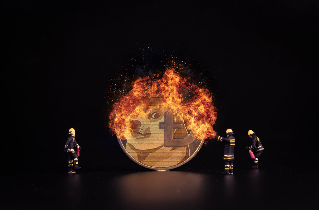 Dogecoin on fire and miniature firefighters