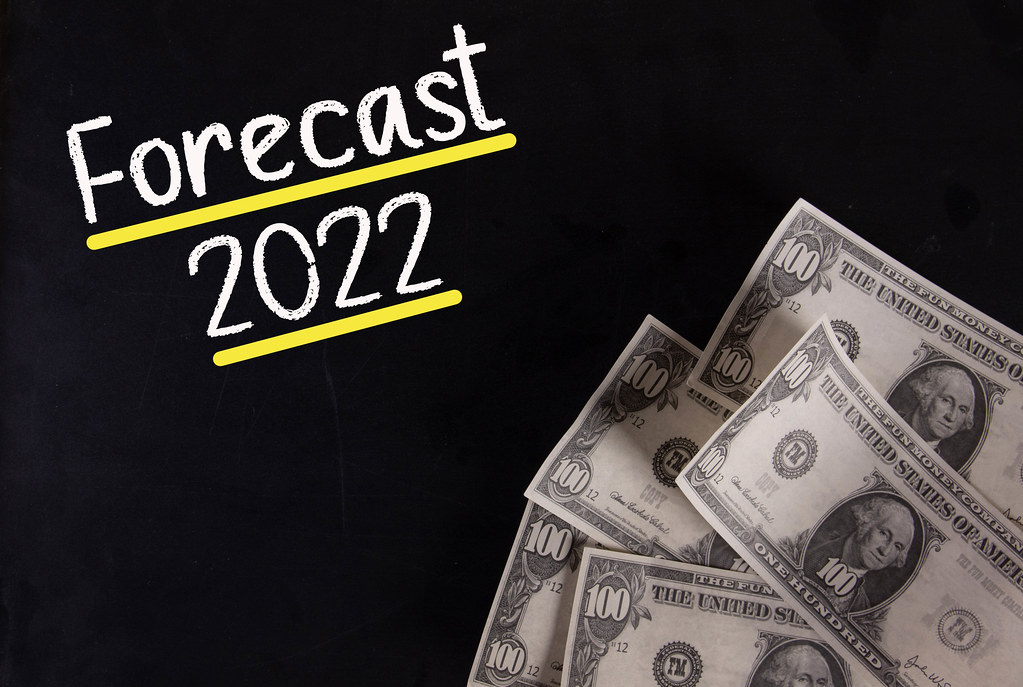 Dollar banknotes with Forecast 2022 text