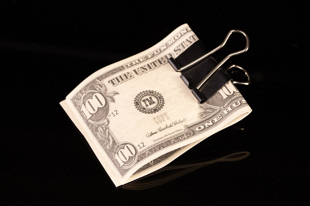 Dollars in money clip on black background