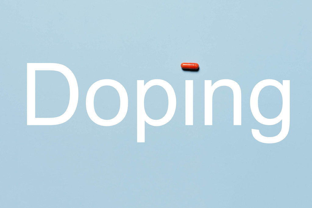 Doping concept on bright blue background
