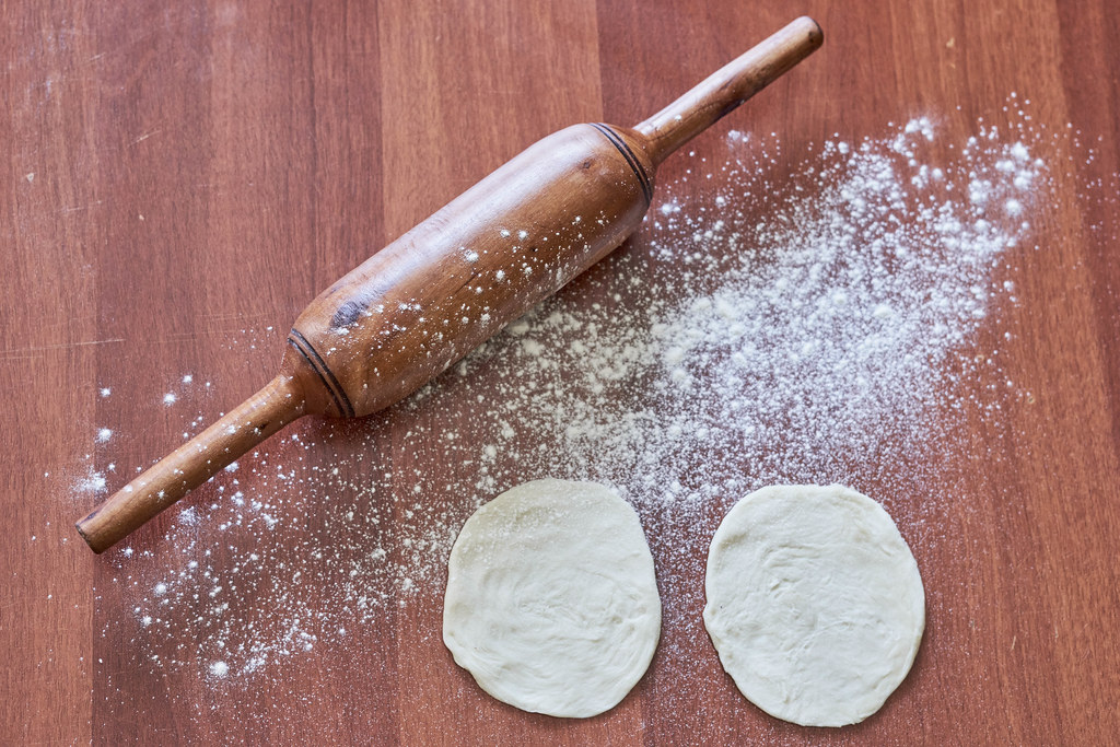 Dough flour and rolling pin on wooden table