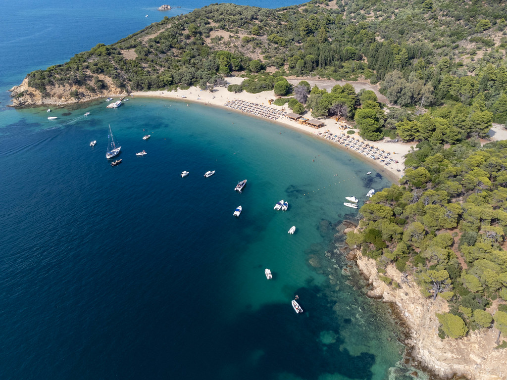 Drone pic of boats in front of the fine sand beach of Tsoungria, uninhabited islet near Skiathos