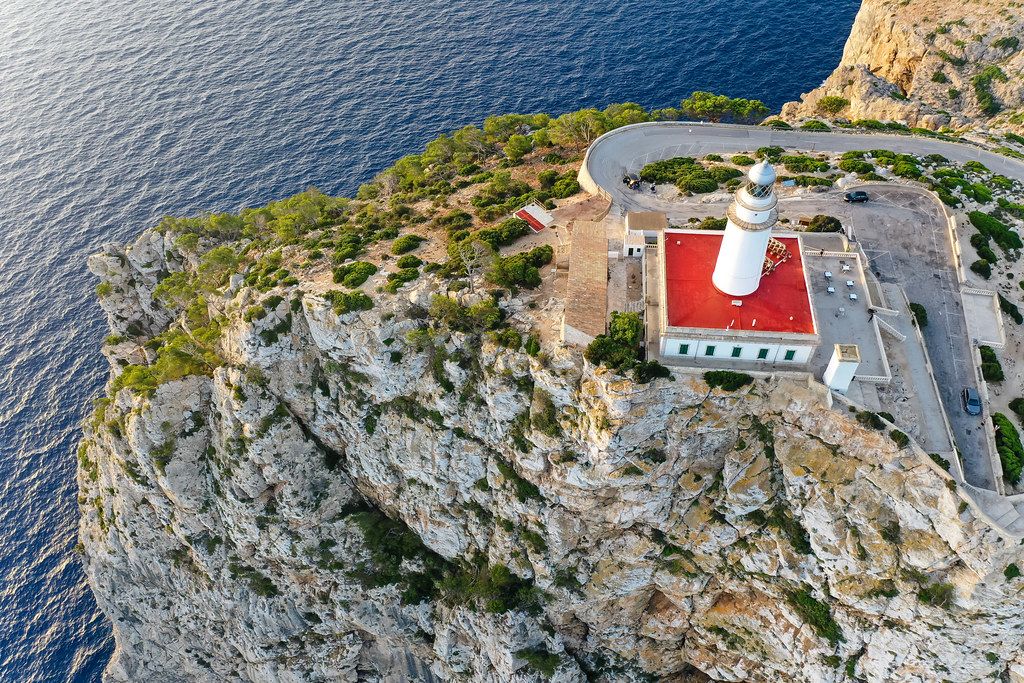 Drone shot, top view of the lighthouse on top of the steep cliff at the tip of Cap de Formentor on Majorca
