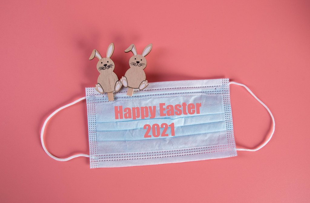 Easter bunnies with medical face mask and Happy Easter 2021 text