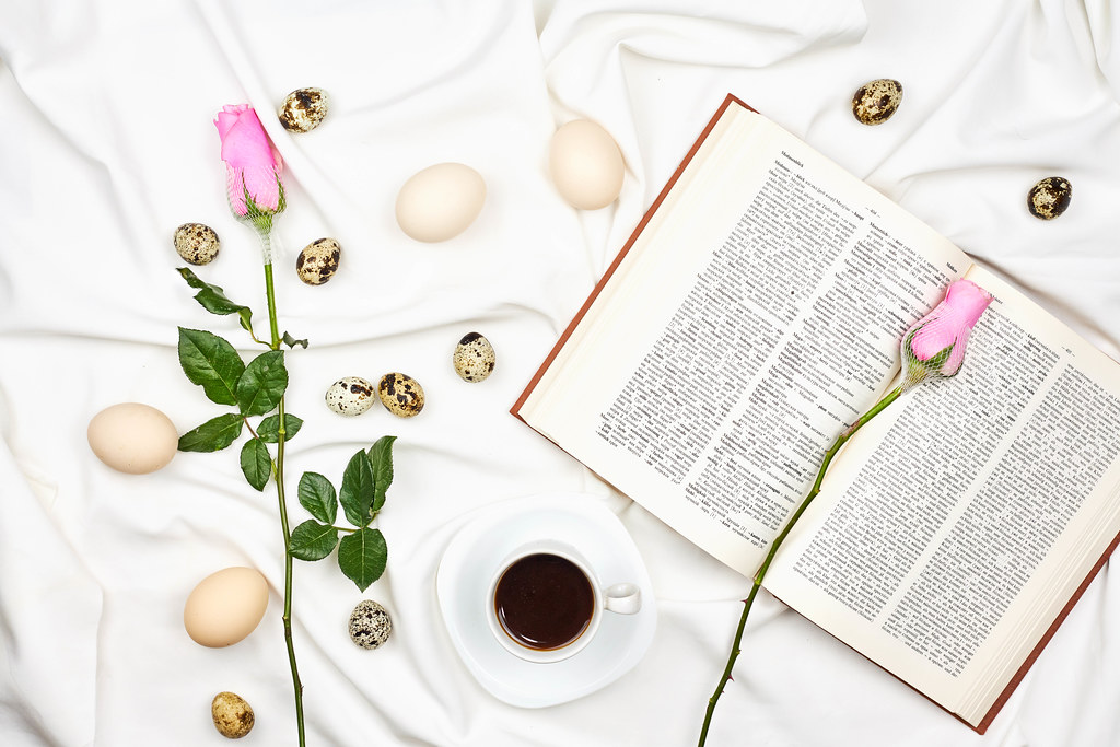 Easter morning with a cute rose flowers, black coffee and book