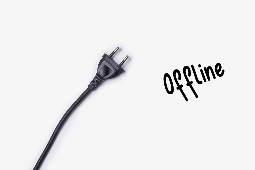 Electric outlet plug and offline text on white background