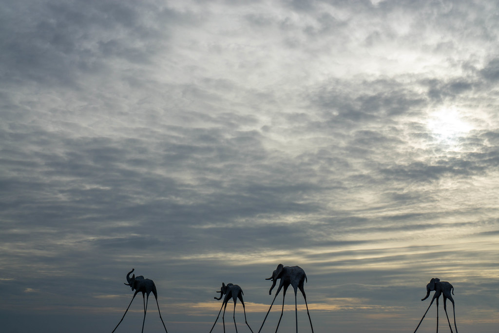 Elephant Sculptures on Sticks in the Sea with Cloudy Sky at Sunset Sanato Beach Club in Phu Quoc, Vietnam