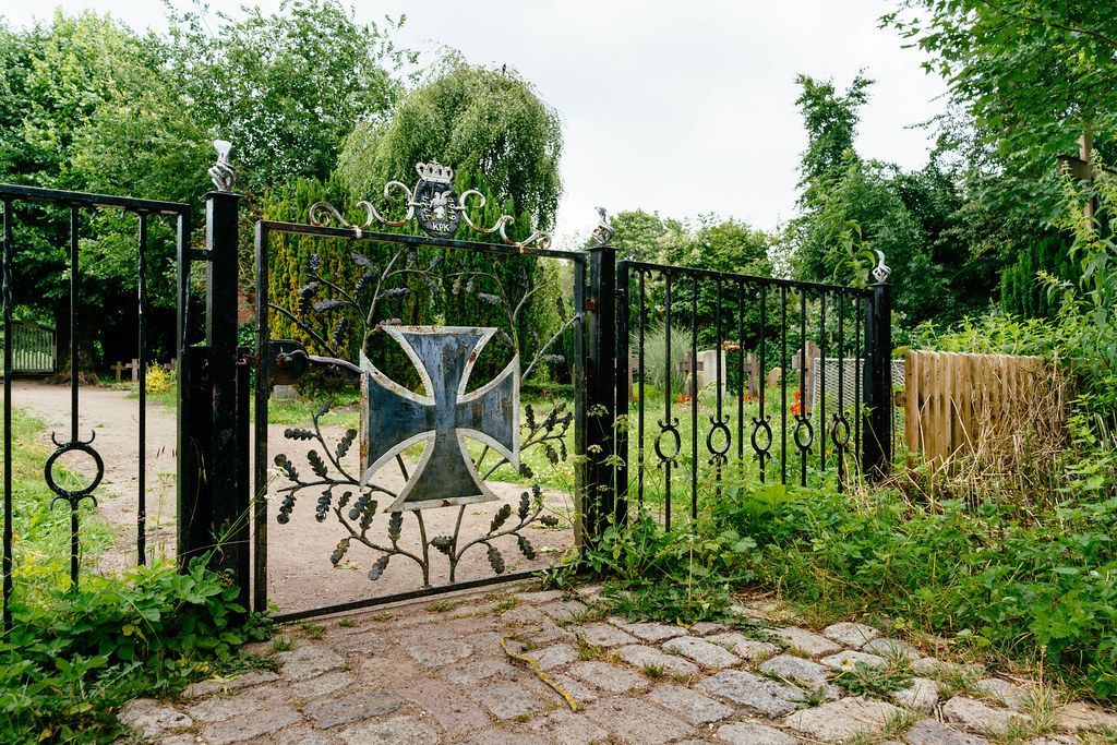 Entrance to the German cemetery with the Iron Cross on the front gate