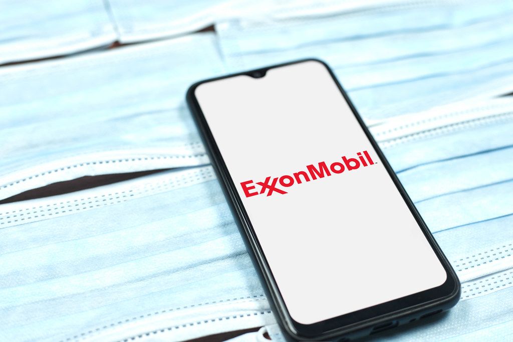 ExxonMobil logo on smartphone screen. American multinational oil and gas corporation during global pandemic