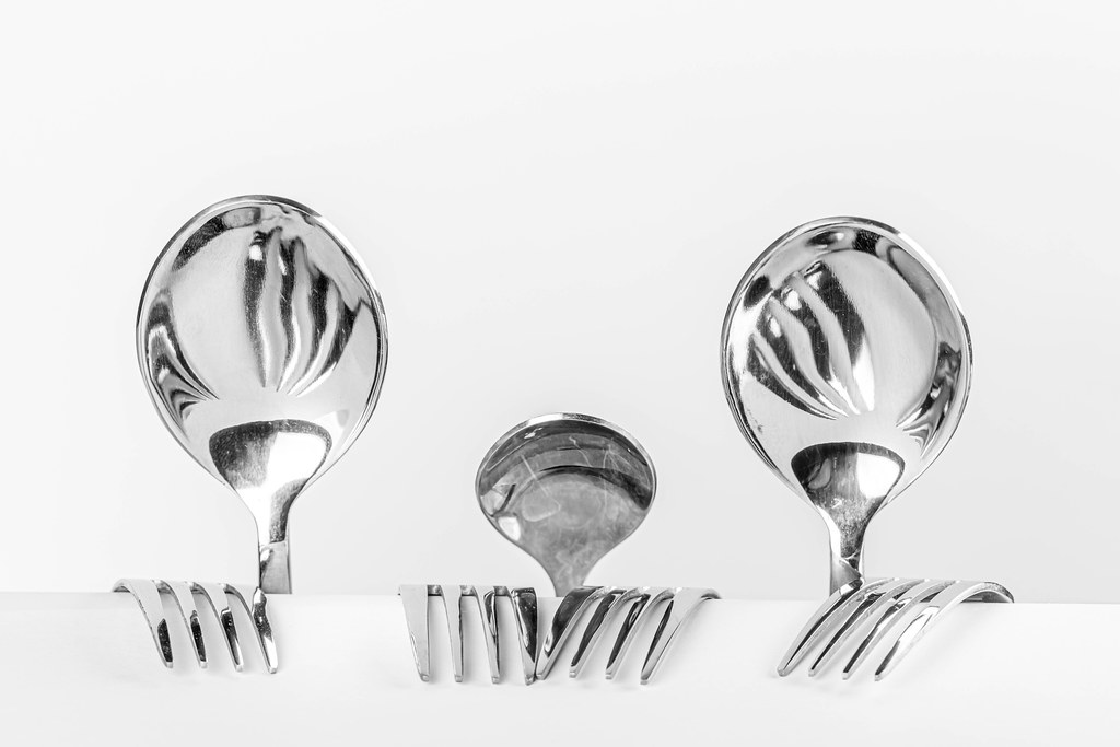 Family of spoons, dad, child and mom of spoons, teaspoon and forks