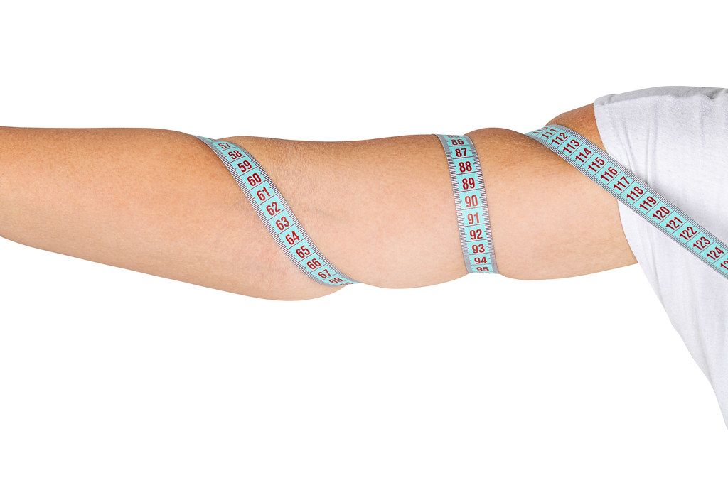 Female hand with measuring tape. Weight loss concept