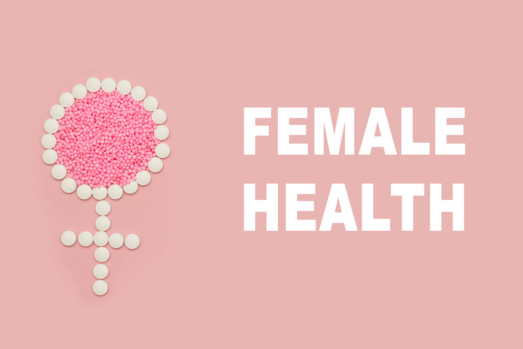 Female health and sign on bright colored background